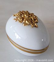 Top perspective showing gold floral appliqué and white porcelain body