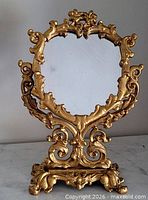 Full view of gilt metal swing mirror