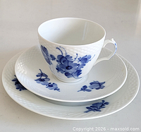 Cup, saucer and plate stacked, showing overall pattern