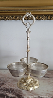 Full view of silver-plated serving stand showing three bowls and handle