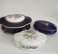 Group view of three porcelain trinket boxes