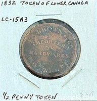 Token obverse in holder with handwritten notes