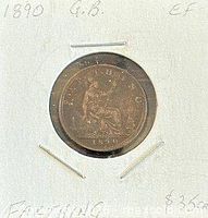 Coin in 2x2 flip showing reverse seated Britannia design, year 1890 visible
