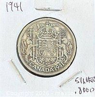 Coin in cardboard flip showing reverse side and handwritten year
