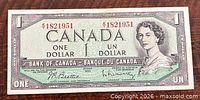 Obverse of 1954 Bank of Canada $1 note showing Queen Elizabeth II portrait and serial number