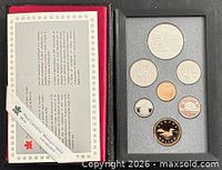 Open case showing seven proof coins and certificate
