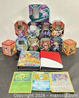 Full lot showing tins stacked, two binders, three cards