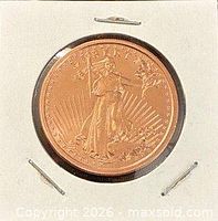 Obverse view of copper round within cardboard flip