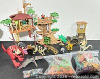 Full lot overview with playsets, dinosaurs, accessories bagged