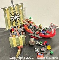 Overall lot showing both ships, figures, cannon and accessories