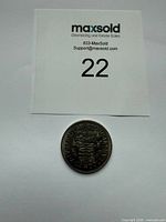 Coin with lot card for scale and identification