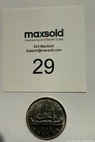 Coin with lot number card showing obverse design