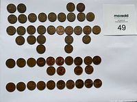Full set of 54 Canadian pennies laid out for count verification