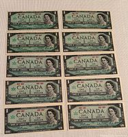 Ten 1967 Centennial Canadian one-dollar bills laid out in two rows