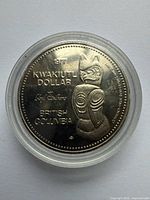 Reverse side with totem design and inscriptions 1977 Kwakiutl Dollar British Columbia