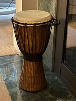 Full view of carved wood djembe drum