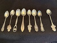 Eight teaspoons laid out bowl up for overall view