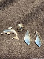 Earrings, ring and brooch laid on fabric