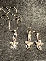 Full view of necklace and both earrings