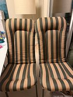 Two tall striped back cushions on chairs