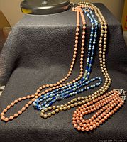 All four necklaces displayed to show full length and strand count