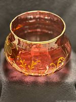 Front view showing cranberry glass color, floral enamel and gold rim