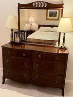 Front view of dresser with mirror and lamps