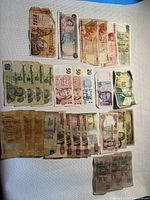 All banknotes laid out flat on fabric surface showing type and quantity