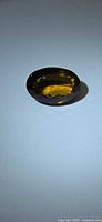 Top view of oval Madeira citrine showing colour and cut