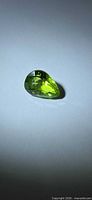 Top view of green pear-shaped checkerboard peridot
