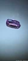 Rectangular cushion cut pink kunzite on neutral background