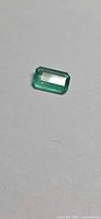 Rectangular emerald-cut green gemstone front view