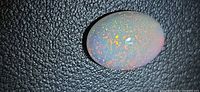 Front view of oval opal cabochon showing pinfire pattern