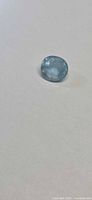 Front view of oval lagoon blue aquamarine on plain background