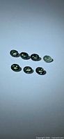 Seven oval sapphires displayed on light background
