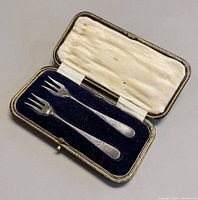 Forks seated in case displaying interior lining and exterior edge