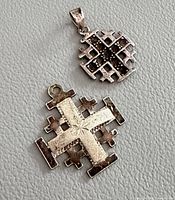 Front view of both Jerusalem cross pendants showing designs and stone accents