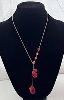 Full view of Y-necklace on display bust showing chain and bead drop