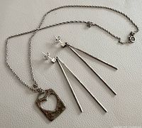 Necklace and pair of sterling earrings laid flat