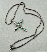 Full view of sterling silver box chain with turquoise cross heart pendant