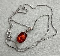Full view of sterling box chain and amber cabochon pendant