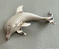 Front view of sterling dolphin brooch