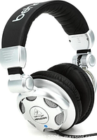 Angled view of Behringer HPX2000 headphones showing silver earcup, ventilation grilles, hinge, and padded headband