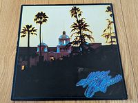 Front cover with palm trees and blue neon title