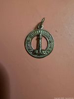 Front view of circular Bermuda charm pendant