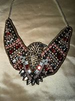 Close-up of bird-motif centerpiece showing bead colors and arrangement