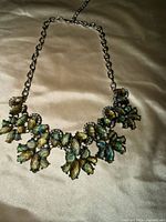 Front view of necklace showing green stones and design