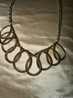 Full view of necklace laid flat showing design and length