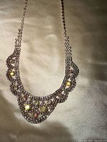 Front view of full necklace showing scalloped rhinestone bib