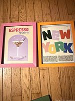 Both framed prints side by side on floor